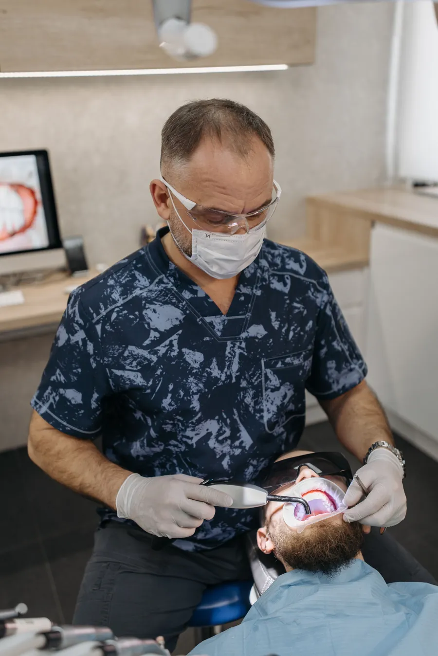 Oral surgeon treating a patient in a modern dental clinic